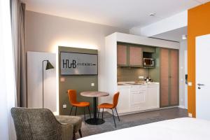 a room with a kitchen with a table and chairs at HUB Apartments St Georg in Hamburg +61 photos