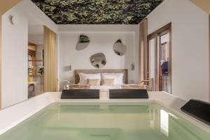 a bedroom with a bed and a swimming pool at Aquasuite - Luxury Experience & Spa in Palermo +79 photos