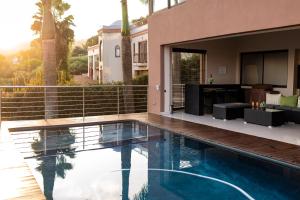 a house with a swimming pool next to a house at Schimper View Boutique Guest House in Louis Trichardt