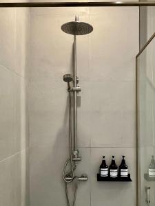 a shower with three bottles on a shelf in a bathroom at PANI Place Khaolak in Khao Lak +14 photos