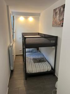 a small bedroom with a bunk bed in a room at Alex's House Fregene in Fregene