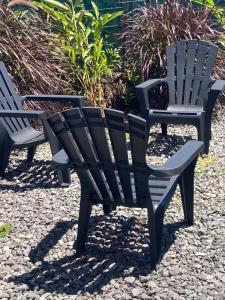 a couple of chairs sitting on top of rocks at les petits galets in Sainte-Rose
