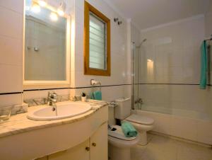 a bathroom with a sink and a toilet and a shower at Harmony Seafront 365 by Can Ventet in Port de Pollensa