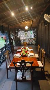 a dining room with a wooden table and chairs at Rahsia Riverside Orchard at Janda Baik , Pahang in Bentong