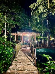 a bridge over a body of water at night at Rahsia Riverside Orchard at Janda Baik , Pahang in Bentong