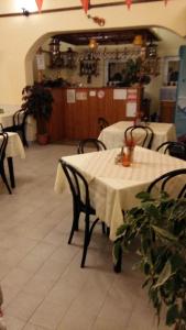 a restaurant with two tables with white table cloth at Camping Eldorado in Gilău
