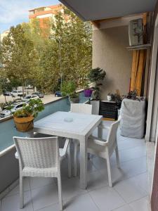 a white table and chairs on a balcony at Luxury Apartments in Vlorë