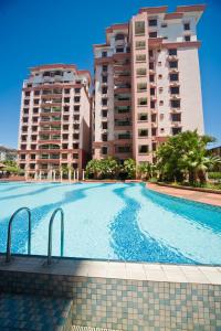 a swimming pool in front of two tall buildings at Nana Marina Court in Kota Kinabalu