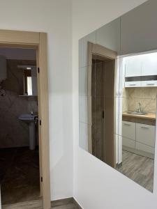 a bathroom with a sink and a mirror at Apartman Milanović in Pribojska Banja +1 photo