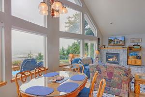 a living room with a table and chairs and a fireplace at Sand Castle Bluff in Moclips