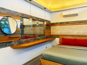 a bedroom with a bed and a mirror at Cafe'@luv22 in Phuket Town