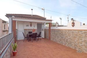 a balcony of a house with a table and chairs at Casa Filo Vistas Montaña in Rute