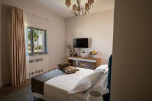 Postel nebo postele na pokoji v ubytování Tenuta Barone Resort & Spa