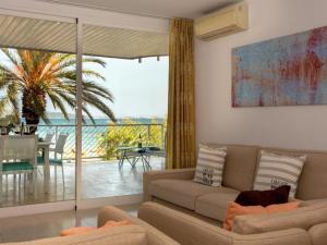 a living room with a couch and a large window at Harmony Seafront 365 by Can Ventet in Port de Pollensa