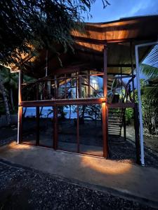 a wooden building with a window at night at Popochos Beach Eco Lodge in Nuquí