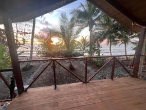 a view of a beach with palm trees and the ocean at Popochos Beach Eco Lodge in Nuquí