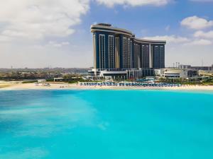 a view of a hotel with a beach and the ocean at Rixos Premium Alamein in El Alamein +135 photos