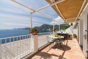 a balcony with a table and a view of the ocean at Calante Luna in Praiano