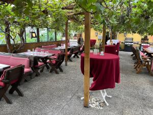 a restaurant with tables and chairs and trees at Hotel-Restaurant Denklinger-Hof in Reichshof 