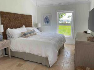 a bedroom with a large bed and a window at Ocean Villa SeaScape in Treasure Cay +53 photos