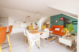 a living room with a table and chairs and a couch at Beautiful 4P accommodation - 10 min to Disney in Montévrain +23 photos