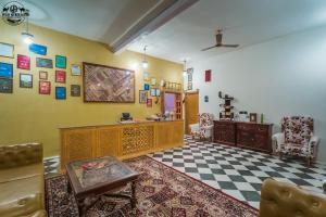 a living room with yellow walls and a checkered floor at Wild Heritage Desert Camp in Jaisalmer