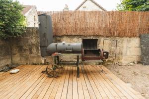 a cannon sitting on a wooden deck next to a fence at Maison Michaut in Aignay-le-Duc