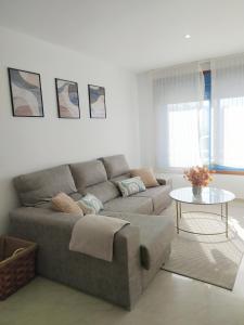 a living room with a couch and a table at Piso Beiramar in Pontevedra