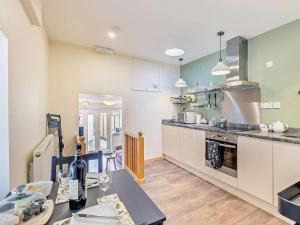 a kitchen with a table with a bottle of wine at 1 Bed in Ross-on-Wye 49910 in Walford
