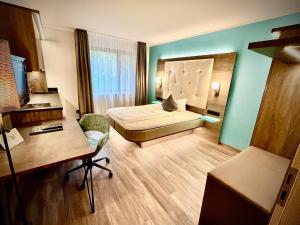 a hotel room with a bed and a desk at Hotel Simonshof in Wolfsburg +36 photos
