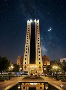 a large building with a moon in the sky at فندق عملاق المشرق in Al Gharīth