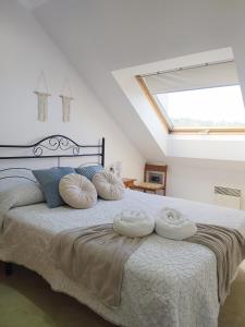 a bedroom with a large bed with two pillows on it at Piso Beiramar in Pontevedra