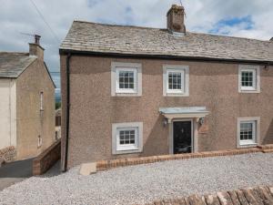 a brick house with a driveway in front of it at 4 Bed in Hackthorpe SZ321 in Hackthorpe