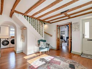 a living room with a chair and a staircase at 3 Bed in Amberley 89898 in Woodchester