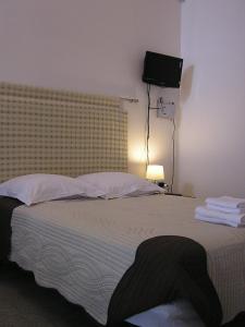 a bedroom with a large bed with a television on the wall at Art Transparent B&B in Grottaglie