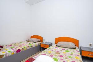 a bedroom with two beds and two tables at Lifto Hostel in Voyvodinovo