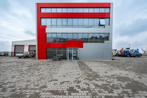 a red and white building in a parking lot at Lifto Hostel in Voyvodinovo