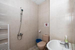a bathroom with a toilet and a sink and a shower at Lifto Hostel in Voyvodinovo