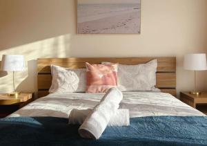 a bed with a pair of socks on top of it at Morden Sandy Bay Home The Ultimate Base in Hobar in Sandy Bay +13 photos