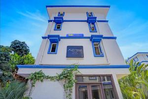 a white building with blue trim at Via PRG Park in Benaulim +8 photos
