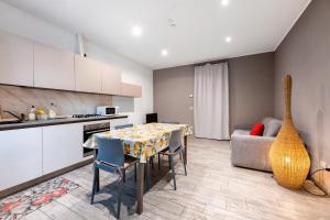 a kitchen and living room with a table and a couch at La Casa Di Beppe - Val d'Intelvi in Lanzo dʼIntelvi