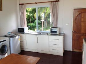 a kitchen with a sink and a window at Nakara Samui-2 bedrooms Ocean View in Ban Thong Phlu