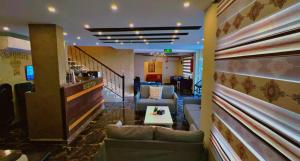a lobby of a hotel with couches and a bar at Shaqilath Hotel in Wadi Musa