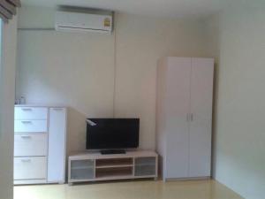 a living room with a tv and a white refrigerator at Nakara Samui S2 One Bedroom Apt in Ban Thong Phlu