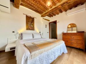 a bedroom with a large bed and a dresser at TRUFFLE'N'BED in San Giovanni dʼAsso