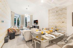 a living room with a dining table and a living room at Luxury Apartments - Urban Oasis by Missoni - Business Bay - Canal View - 10 Minutes from Dubai Mall Burj Khalifa in Dubai