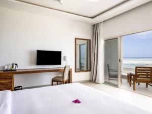 a hotel room with a bed and a view of the ocean at Nungwi Dreams by Mantis in Nungwi +129 photos