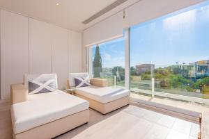 a bedroom with two beds and a large window at Can Bosquerró in Sa Ràpita +39 photos