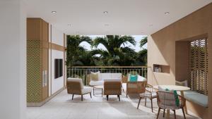 eine Terrasse mit Stühlen, einer Couch und einem Tisch in der Unterkunft Maraleina Sports Resort in Nathon Bay