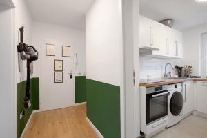 a kitchen with green and white walls at Business Apartment in Oberkochen in Oberkochen